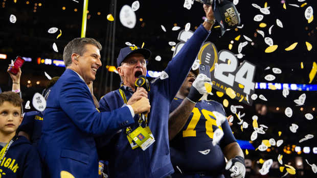 Jack Harbaugh, father of Michigan Wolverines head coach Jim Harbaugh (not pictured), is interviewed by Reece Davis as he celebrates after winning the 2024 College Football Playoff national championship game against the Washington Huskies at NRG Stadium. © Mark J. Rebilas-USA TODAY Sports