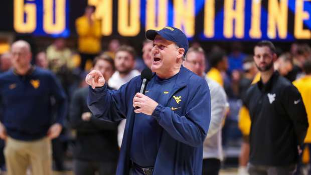 Feb 19, 2025; Morgantown, West Virginia, USA; West Virginia Mountaineers head football coach Rich Rodriguez speaks to the crowd during a timeout during the first half against the Cincinnati Bearcats at WVU Coliseum. Mandatory Credit: Ben Queen-Imagn Images
