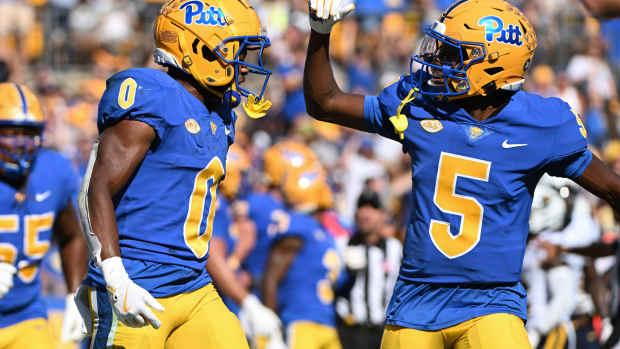 Sep 14, 2024; Pittsburgh, Pennsylvania, USA; Pittsburgh Panthers running back Desmond Reid celebrates with Raphael Williams Jr. (5) after a touchdown against the West Virginia Mountaineers during the second quarter at Acrisure Stadium. Mandatory Credit: Barry Reeger-Image Images