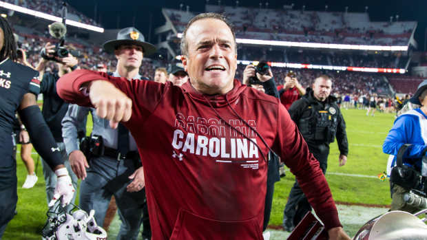 Nov 16, 2024; Columbia, South Carolina, USA; South Carolina Gamecocks head coach Shane Beamer celebrates beating the Missouri Tigers at Williams-Brice Stadium. He is holding the Mayors Cup, given to the winner of the South Carolina-Missouri game. Mandatory Credit: Jeff Blake-Imagn Images