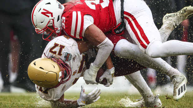 Dec 28, 2024; Bronx, NY, USA; Boston College Eagles tight end Jeremiah Franklin (17) is tackled by Nebraska Cornhuskers linebacker Javin Wright (33) during the first half at Yankee Stadium. Mandatory Credit: Vincent Carchietta-Imagn Images