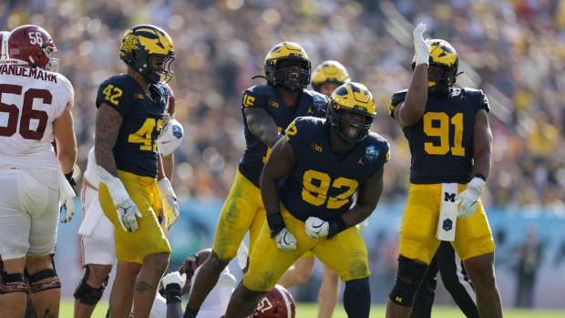 Dec 31, 2024; Tampa, FL, USA; Alabama Crimson Tide quarterback Jalen Milroe (4) is sacked by Michigan Wolverines defensive lineman Ike Iwunnah (92) in the third quarter during the ReliaQuest Bowl at Raymond James Stadium. Mandatory Credit: Nathan Ray Seebeck-Imagn Images