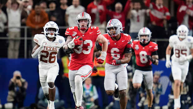 Ohio State Buckeyes defensive end Jack Sawyer (33) returns a fumble recovery for a touchdown after sacking Texas Longhorns quarterback Quinn Ewers (3) during the second half of the Cotton Bowl Classic College Football Playoff semifinal game at AT&T Stadium in Arlington, Texas on Jan. 10, 2025. Sawyer returned the fumble for a touchdown, and Ohio State won 28-14.