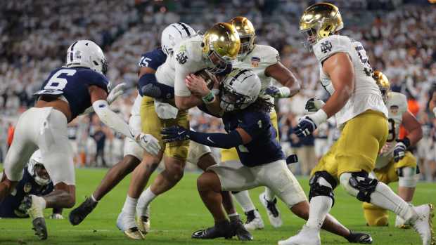 Jan 9, 2025; Miami, FL, USA; Notre Dame Fighting Irish quarterback Riley Leonard (13) runs the ball in the second half against the Penn State Nittany Lions in the Orange Bowl at Hard Rock Stadium. Mandatory Credit: Sam Navarro-Imagn Images