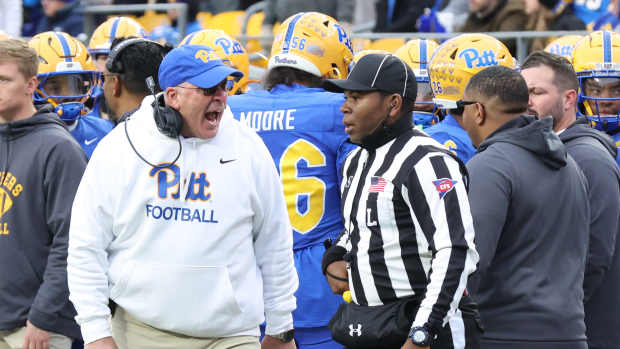 Nov 29, 2025; Pittsburgh, Pennsylvania, USA; Pittsburgh Panthers head coach Pat Narduzzi (left) reacts to line judge Josiah Ford (right) during the third quarter against the Miami Hurricanes at Acrisure Stadium. Mandatory Credit: Charles LeClaire-Imagn Images