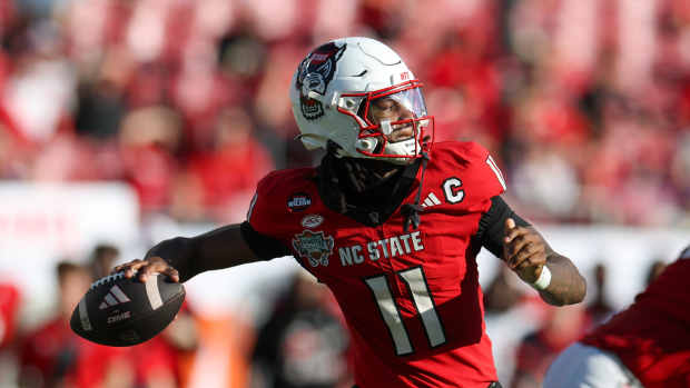 Dec 19, 2025; Tampa, FL, USA; NC State Wolfpack quarterback CJ Bailey (11) throws a pass against the Memphis Tigers in the second quarter during the Gasparilla Bowl at Raymond James Stadium. Mandatory Credit: Nathan Ray Seebeck-Imagn Images