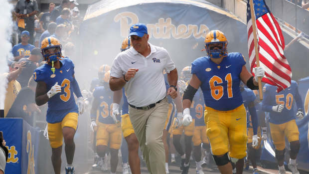 Aug 31, 2024; Pittsburgh, Pennsylvania, USA; Pittsburgh Panthers defensive back Donovan McMillon (3) and head coach Pat Narduzzi and Pittsburgh Panthers offensive lineman Ryan Jacoby (61) lead the team onto the field against the Kent State Golden Flashes at Acrisure Stadium. Mandatory Credit: Charles LeClaire-Imagn Images