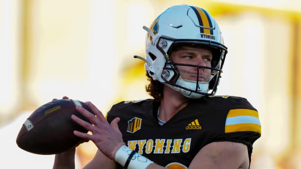 Oct 26, 2024; Laramie, Wyoming, USA; Wyoming Cowboys quarterback Kaden Anderson (12) warms up before the game against the Utah State Aggies at Jonah Field at War Memorial Stadium. Mandatory Credit: Troy Babbitt-Imagn Images