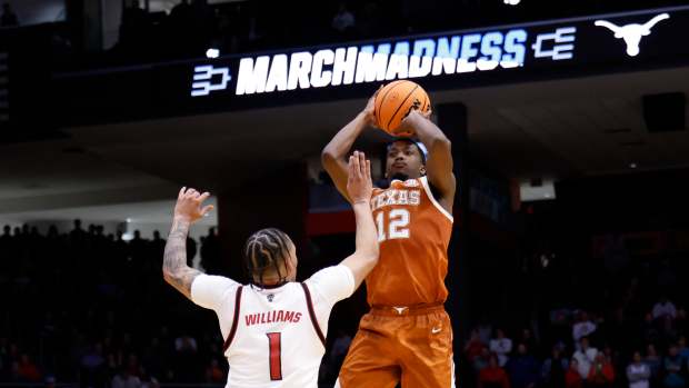 Mar 17, 2026; Dayton, OH, USA; Texas Longhorns guard Tramon Mark (12) shoots the ball over NC State Wolfpack forward Darrion Williams (1) in the second half during a first four game of the men's 2026 NCAA Tournament at University of Dayton Arena. Mandatory Credit: Rick Osentoski-Imagn Images