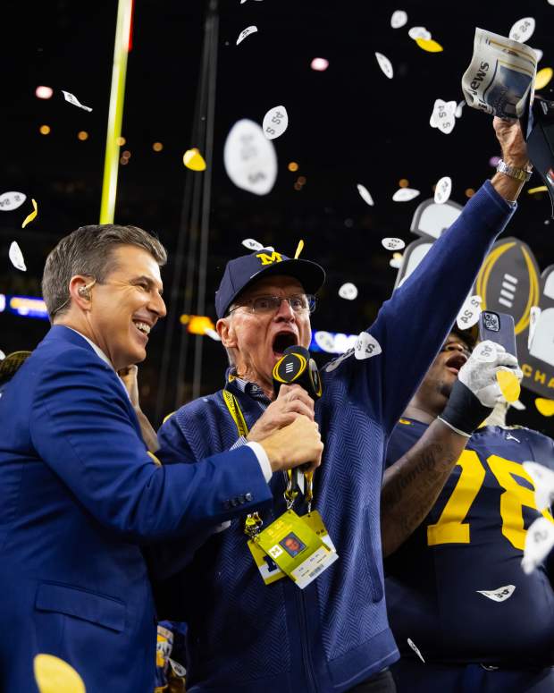 Jack Harbaugh, father of Michigan Wolverines head coach Jim Harbaugh (not pictured), is interviewed by Reece Davis as he celebrates after winning the 2024 College Football Playoff national championship game against the Washington Huskies at NRG Stadium. © Mark J. Rebilas-USA TODAY Sports