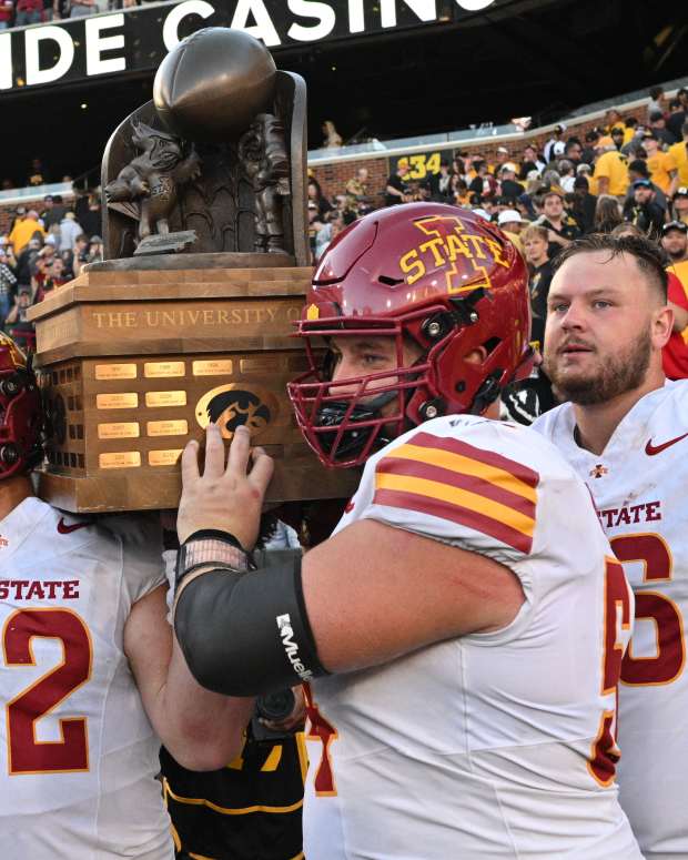 Sep 7, 2024; Iowa City, Iowa, USA; Iowa State Cyclones defensive end Joey Petersen (52) and offensive lineman Jarrod Hufford (54) and offensive lineman Tyler Miller (66) carry the Cy-Hawk trophy after the game against the Iowa Hawkeyes at Kinnick Stadium. Mandatory Credit: Jeffrey Becker-Imagn Images