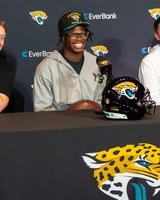 Jacksonville Jaguars ead Coach Liam Coen, left, has a laugh with Jacksonville Jaguars’ first-round pick, Colorado Buffaloes wide receiver and defensive back Travis Hunter, center, during a press conference Friday, March 25, 2025 at Miller Electric Center in Jacksonville, Fla. with General Manager James Gladstone, right. [Doug Engle/Florida Times-Union]