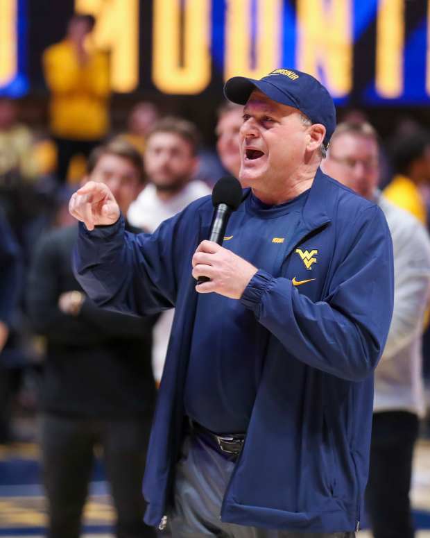 Feb 19, 2025; Morgantown, West Virginia, USA; West Virginia Mountaineers head football coach Rich Rodriguez speaks to the crowd during a timeout during the first half against the Cincinnati Bearcats at WVU Coliseum. Mandatory Credit: Ben Queen-Imagn Images