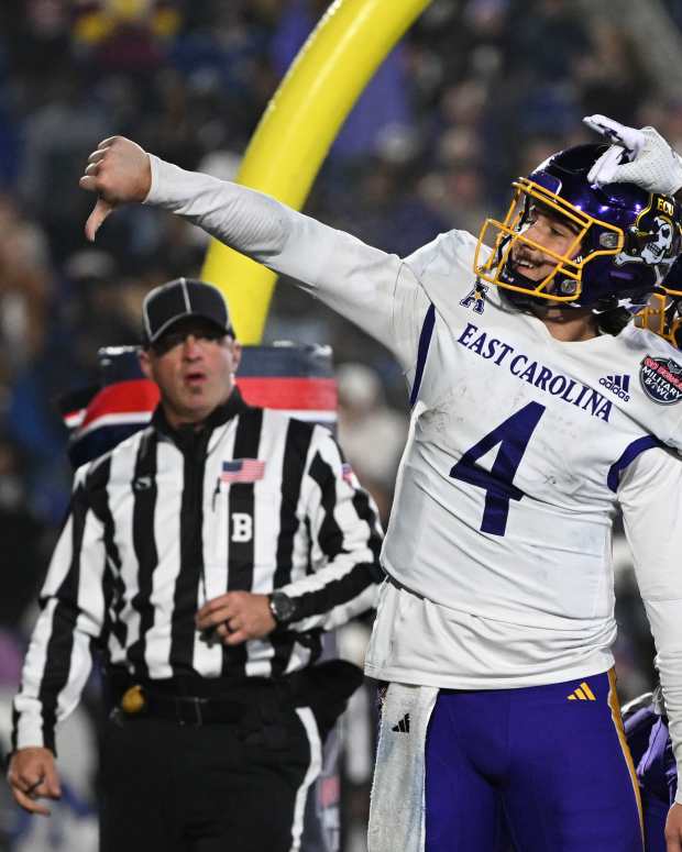 Dec 28, 2024; Annapolis, MD, USA; East Carolina Pirates quarterback Katin Houser (4) celebrates with teammates after scoring a touchdown during the second half of the Go Bowling Military Bowl against the North Carolina State Wolfpack at Navy-Marine Corps Memorial Stadium. Mandatory Credit: Tommy Gilligan-Imagn Images