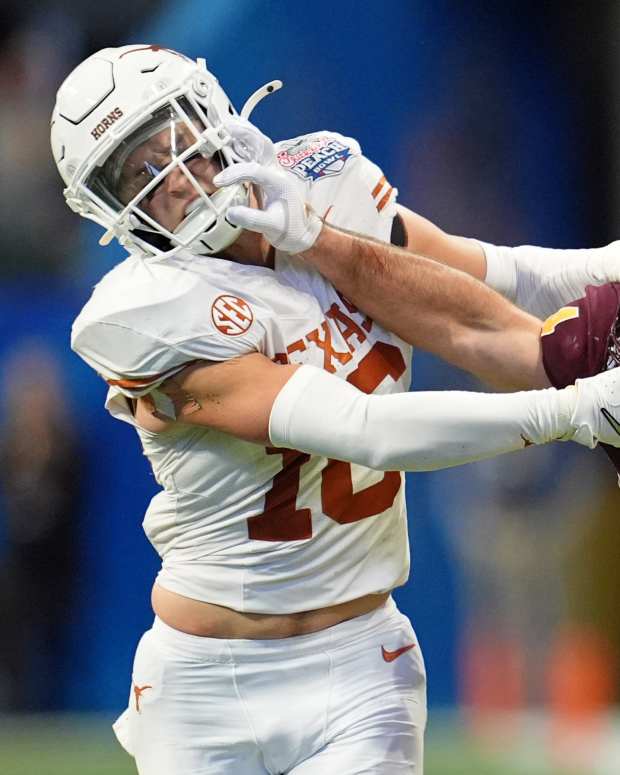 Jan 1, 2025; Atlanta, GA, USA; Arizona State Sun Devils running back Cam Skattebo (4) and Texas Longhorns defensive back Michael Taaffe (16) push each other during the second half of the Peach Bowl at Mercedes-Benz Stadium. Mandatory Credit: Dale Zanine-Imagn Images