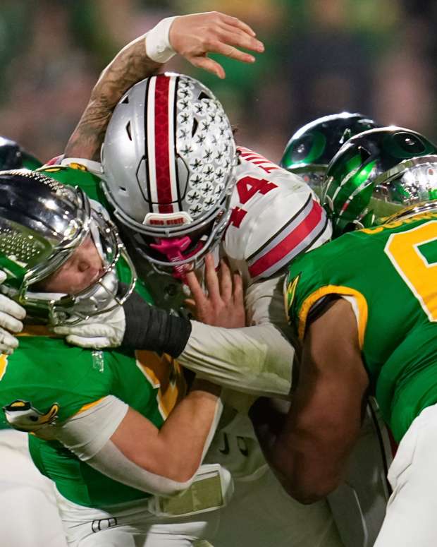 Ohio State defensive end JT Tuimoloau (44) hits Oregon quarterback Dillon Gabriel during the second half of the College Football Playoff quarterfinal at the Rose Bowl in Pasadena, Calif. on Jan. 1, 2025.