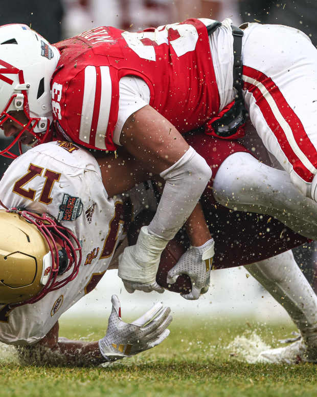 Dec 28, 2024; Bronx, NY, USA; Boston College Eagles tight end Jeremiah Franklin (17) is tackled by Nebraska Cornhuskers linebacker Javin Wright (33) during the first half at Yankee Stadium. Mandatory Credit: Vincent Carchietta-Imagn Images