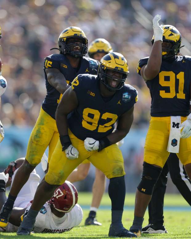 Dec 31, 2024; Tampa, FL, USA; Alabama Crimson Tide quarterback Jalen Milroe (4) is sacked by Michigan Wolverines defensive lineman Ike Iwunnah (92) in the third quarter during the ReliaQuest Bowl at Raymond James Stadium. Mandatory Credit: Nathan Ray Seebeck-Imagn Images