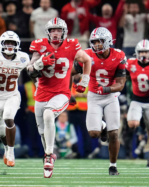 Ohio State Buckeyes defensive end Jack Sawyer (33) returns a fumble recovery for a touchdown after sacking Texas Longhorns quarterback Quinn Ewers (3) during the second half of the Cotton Bowl Classic College Football Playoff semifinal game at AT&T Stadium in Arlington, Texas on Jan. 10, 2025. Sawyer returned the fumble for a touchdown, and Ohio State won 28-14.