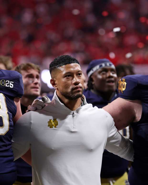 Jan 20, 2025; Atlanta, GA, USA; Notre Dame Fighting Irish offensive lineman Pat Coogan (78), head coach Marcus Freeman, and offensive lineman Rocco Spindler (50) react after losing against the Ohio State Buckeyes in the CFP National Championship college football game at Mercedes-Benz Stadium. Mandatory Credit: Brett Davis-Imagn Images