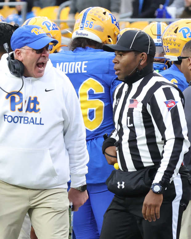Nov 29, 2025; Pittsburgh, Pennsylvania, USA; Pittsburgh Panthers head coach Pat Narduzzi (left) reacts to line judge Josiah Ford (right) during the third quarter against the Miami Hurricanes at Acrisure Stadium. Mandatory Credit: Charles LeClaire-Imagn Images