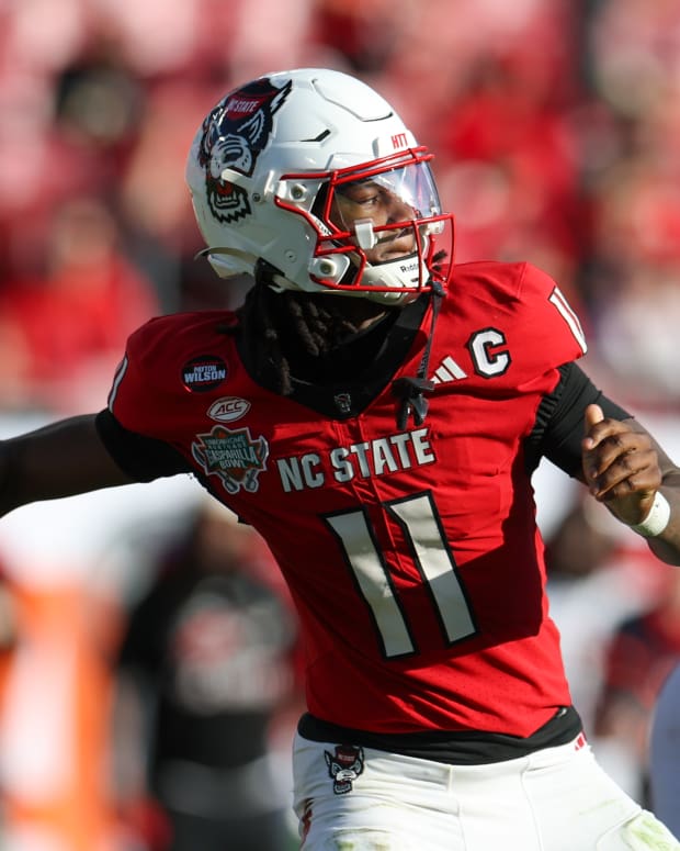 Dec 19, 2025; Tampa, FL, USA; NC State Wolfpack quarterback CJ Bailey (11) throws a pass against the Memphis Tigers in the second quarter during the Gasparilla Bowl at Raymond James Stadium. Mandatory Credit: Nathan Ray Seebeck-Imagn Images