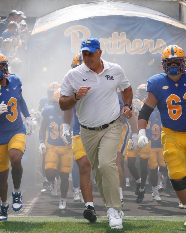 Aug 31, 2024; Pittsburgh, Pennsylvania, USA; Pittsburgh Panthers defensive back Donovan McMillon (3) and head coach Pat Narduzzi and Pittsburgh Panthers offensive lineman Ryan Jacoby (61) lead the team onto the field against the Kent State Golden Flashes at Acrisure Stadium. Mandatory Credit: Charles LeClaire-Imagn Images