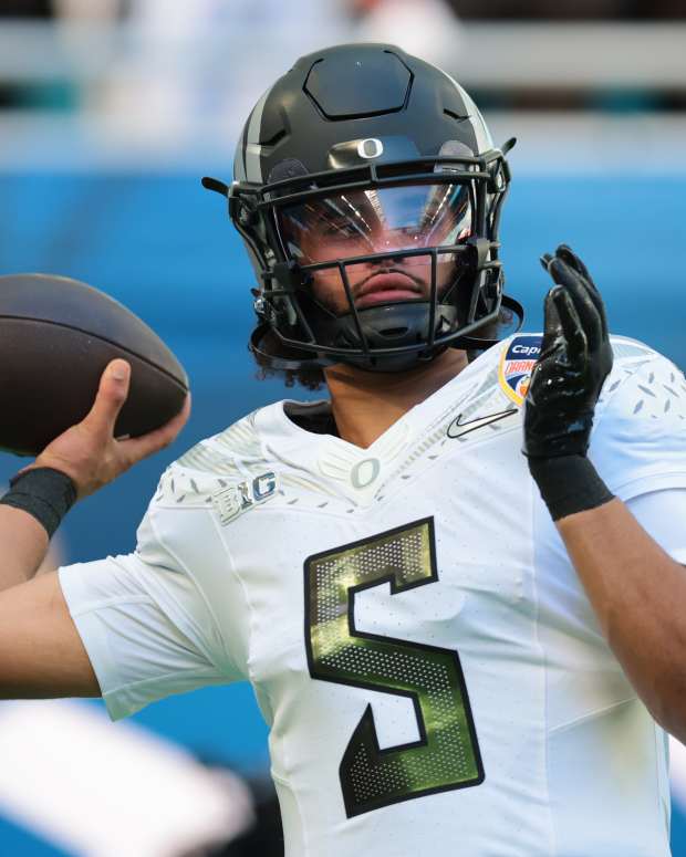 Jan 1, 2026; Miami Gardens, FL, USA; Oregon Ducks quarterback Dante Moore (5) warms up prior to the 2025 Orange Bowl and quarterfinal game of the College Football Playoff against the Texas Tech Red Raiders at Hard Rock Stadium. Mandatory Credit: Sam Navarro-Imagn Images