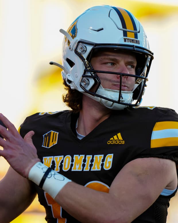Oct 26, 2024; Laramie, Wyoming, USA; Wyoming Cowboys quarterback Kaden Anderson (12) warms up before the game against the Utah State Aggies at Jonah Field at War Memorial Stadium. Mandatory Credit: Troy Babbitt-Imagn Images