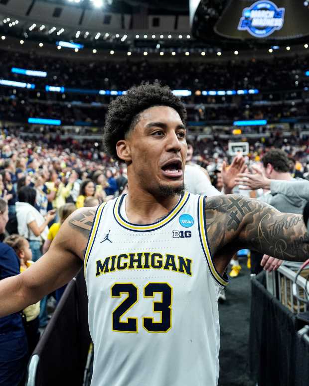 Michigan forward Yaxel Lendeborg (23) high-fives fans to celebrate 90-77 win over Alabama at the NCAA Tournament Sweet 16 round at United Center in Chicago on Friday, March 27, 2026.