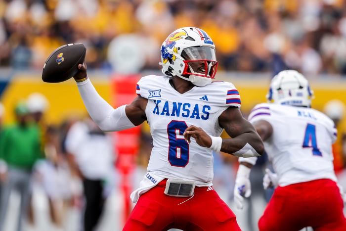 Sep 21, 2024; Morgantown, West Virginia, USA; Kansas Jayhawks quarterback Jalon Daniels (6) throws a pass during the first quarter against the West Virginia Mountaineers at Mountaineer Field at Milan Puskar Stadium. Mandatory Credit: Ben Queen-Imagn Images