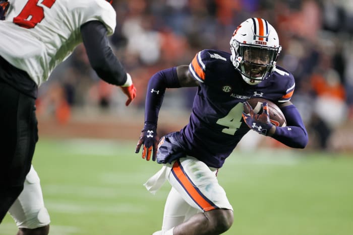 Nov 19, 2022; Auburn, Alabama, USA; Auburn Tigers cornerback D.J. James (4) returns an interception for a touchdown during the fourth quarter against the Western Kentucky Hilltoppers at Jordan-Hare Stadium. Mandatory Credit: John Reed-USA TODAY Sports